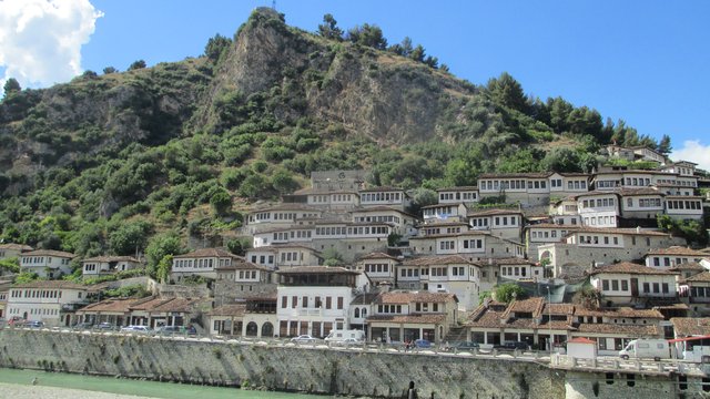 The white Ottoman houses of Berat's Mangalem quarter against the castle hill, above the Osum river