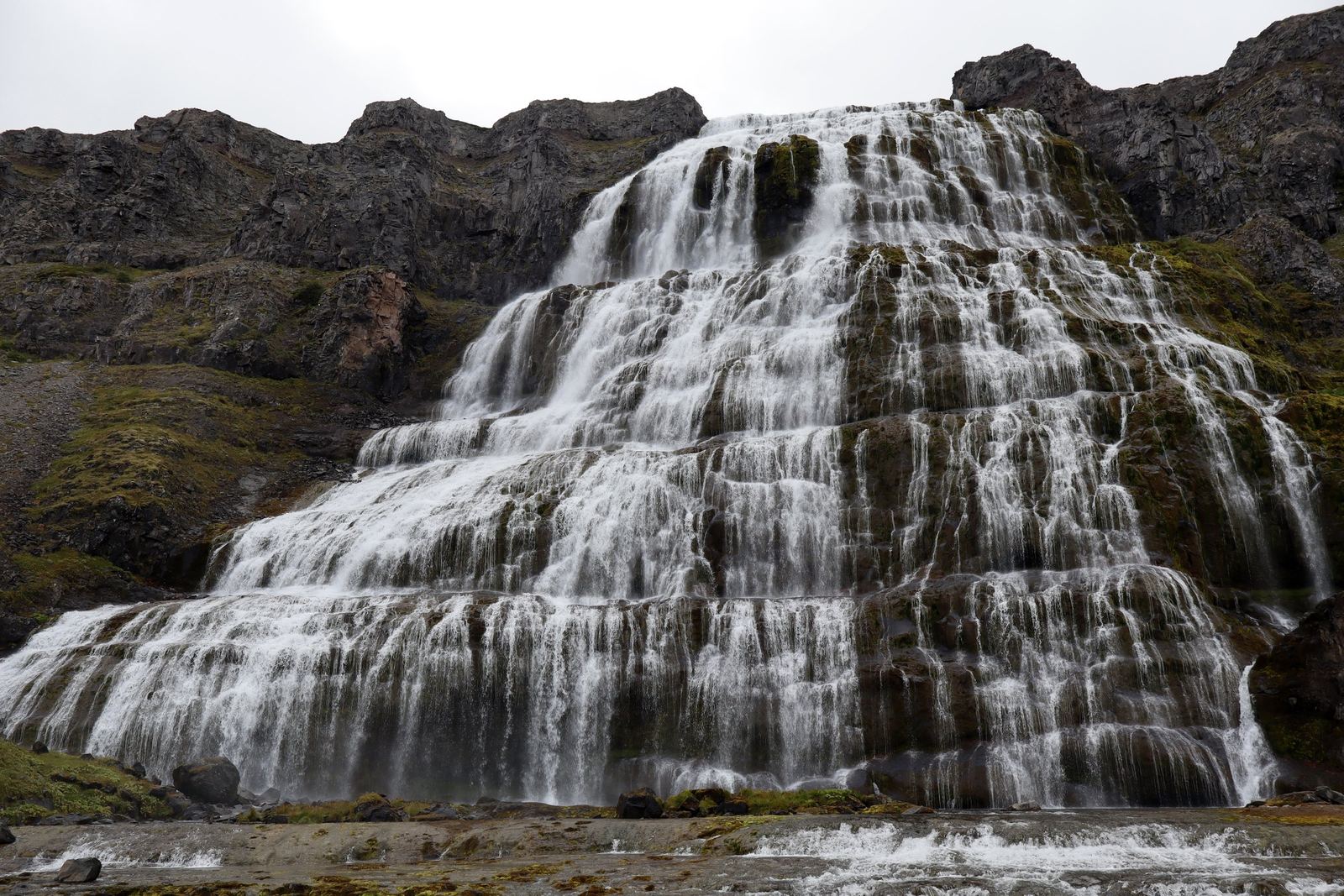 The wide, tiered Dynjandi waterfall cascading over dark rock layers