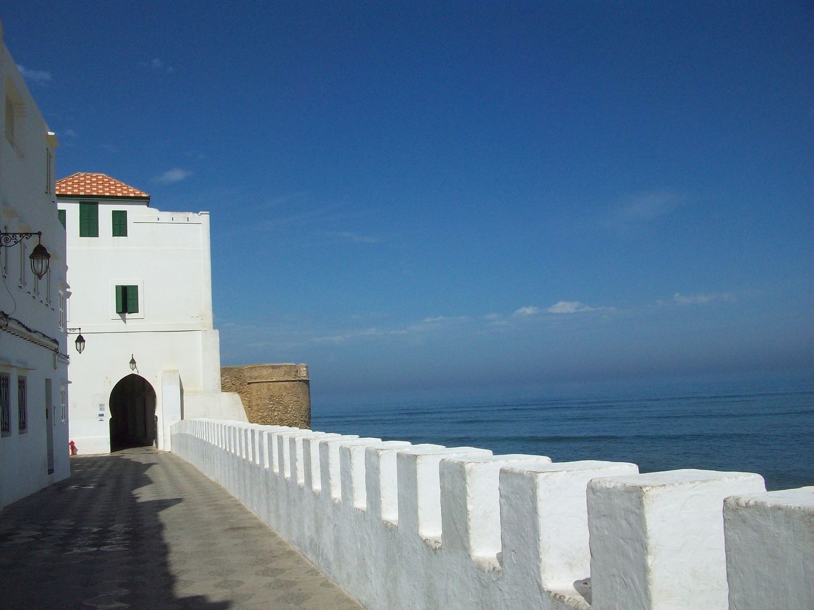 Whitewashed battlements of the Asilah town wall along the Atlantic Ocean