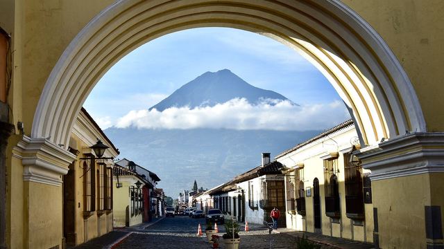 The yellow Santa Catalina arch with Agua volcano in Antigua