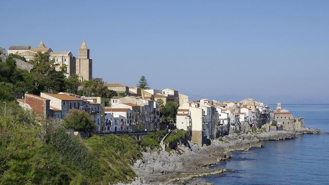 The old town of Cefalù with the cathedral above the sea