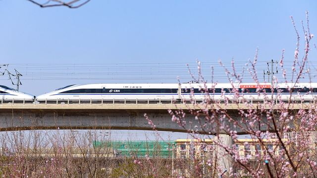 A high-speed train running through the countryside near Shijingshan