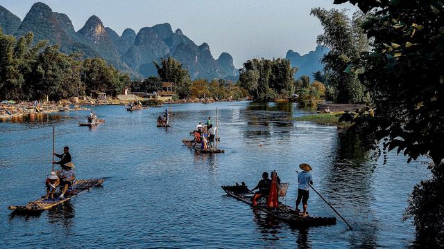 A bamboo raft on the Yulong River between karst peaks