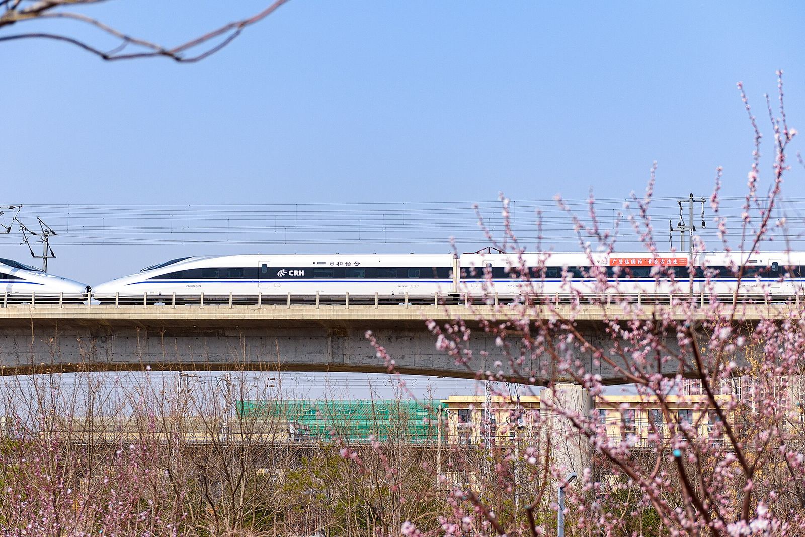 A high-speed train running through the countryside near Shijingshan