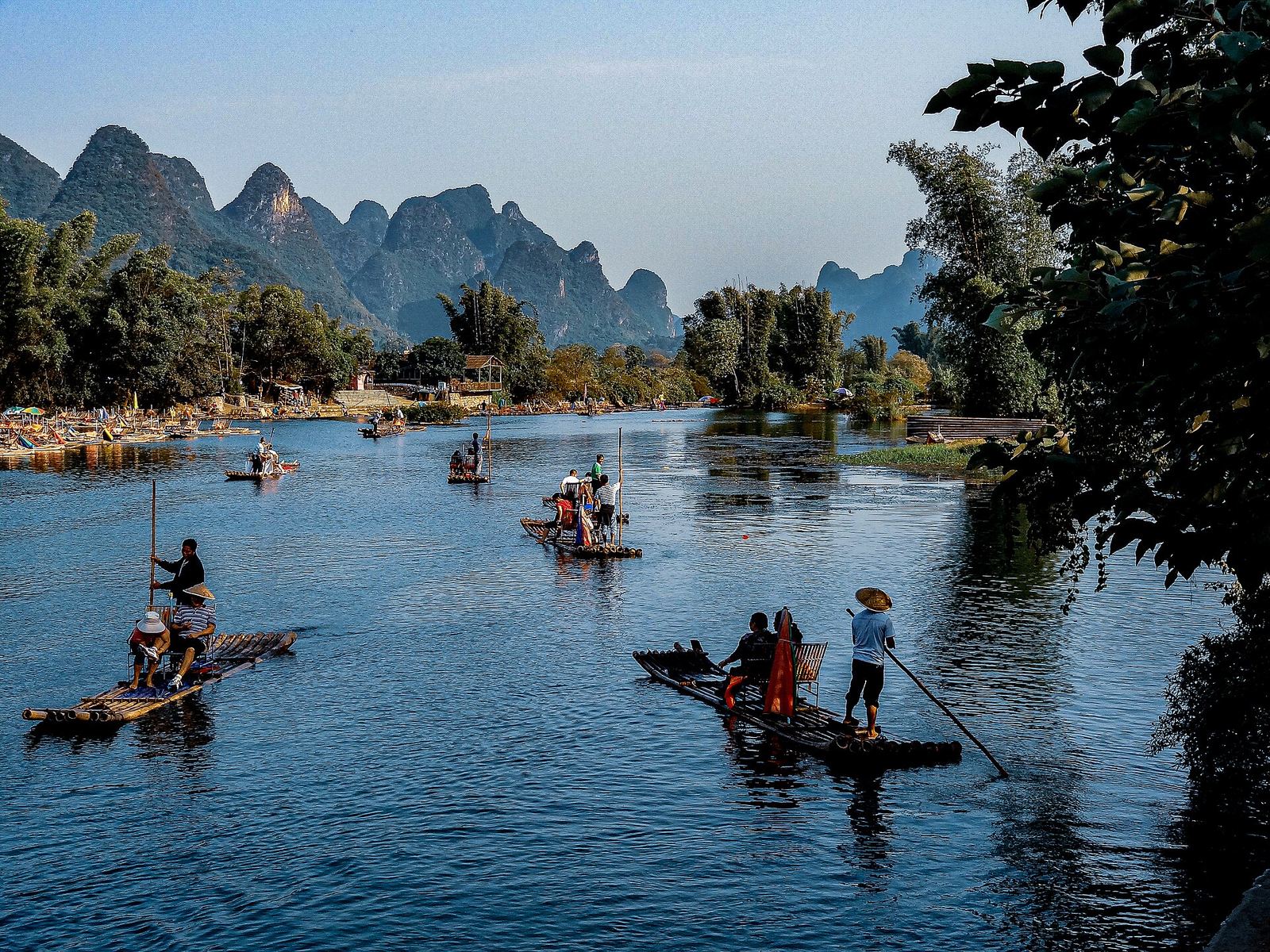 A bamboo raft on the Yulong River between karst peaks